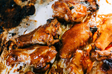 Delicious and Sticky Glazed Barbecue Chicken Wings on a Baking Tray. 