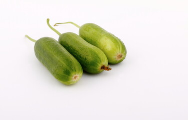 Fresh and green cucumbers on a white background