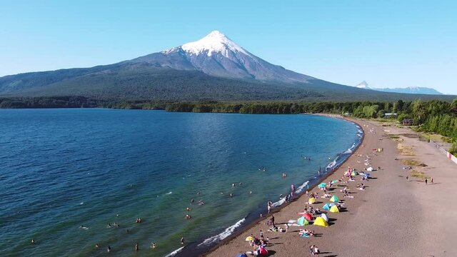 Aerial drone view of volcanic lake called Llanquihue Lake with people on a beach near Osorno Volcano in Chilean Andes. One of most active volcano in Chile similar to Mount Fuji.
Chile.
