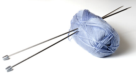 Balls of blue yarn and knitting needles. White background. Copy space. The concept of women 's needlework