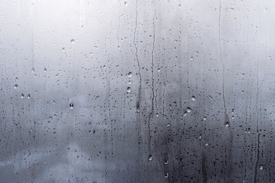 Wet window background. Drops of condensate on the sweaty glass. Closeup