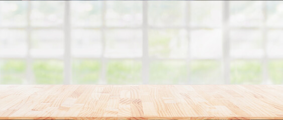 Wood table top on blur kitchen window background, can be used for display or montage your products...