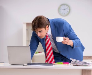 Young attractive businessman working in the office