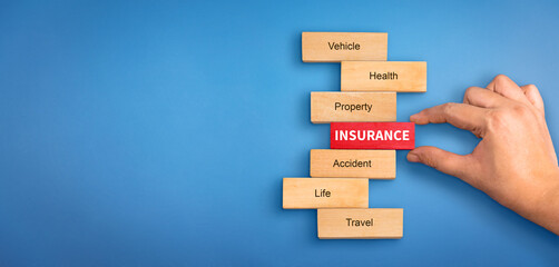 hand holding a wooden block with text insurance, different types of insurance text on wooden block. Insurance  concept, different type of insurance background.