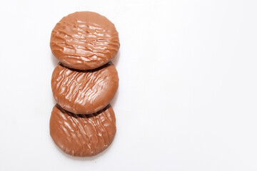 Chocolate Protein bars filled with chocolate sauce, cut on a white background
