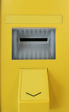 Secure card reader in a yellow public ATM. Safe use of bank cards, the fight against financial fraud. 