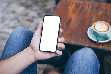 cell phone mockup image blank white screen.man hand holding texting using mobile on desk at coffee shop.background empty space for advertise.work people contact marketing business,technology