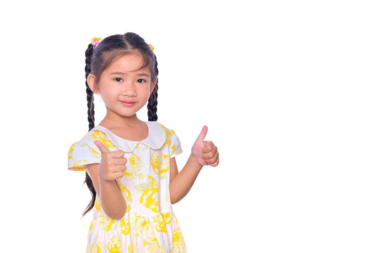 Adorable And Cheerful Asian Kid Giving Thumbs Up And Smile Face Isolated Over White Background