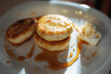 cottage cheese pancakes with honey and sour cream, delicious and healthy Breakfast, beautiful early Sunny morning, healthy food concept