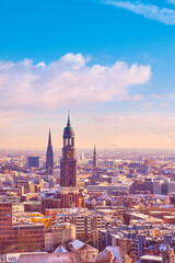 Scenic panorama view from Dancing Towers over Hamburg under snow in winter with St. Michael's...