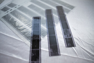 Film photography special  archival envelope slips for negative storage. 35mm and medium format photography. Film strips laying down on a table.