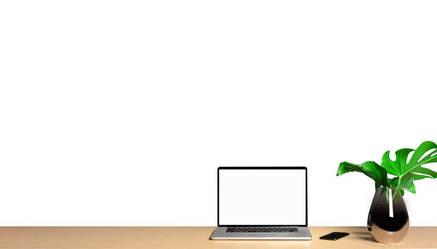 A modern laptop on a wooden table with vases and leaves on the side with a white background. business and technology concept - Powered by Adobe