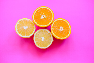 sliced oranges and lemons are laying on the plain backgrounds, colourful fruit, fresh citrus