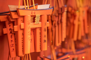 Closeup of Small Torii gates with peoples wishes at Fushimi Inari shrine, Kyoto. Normally Torii is...