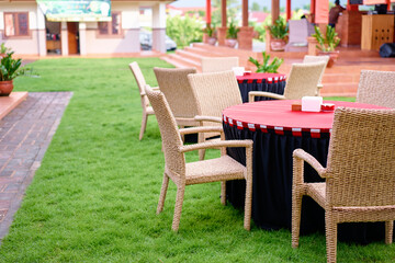 Outdoor cafe with tables on green grass.