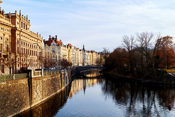 View to the Prague Slavic island with Zofin palace from Legii bridge. Colorful Prague streets landmarks, autumn colors and light