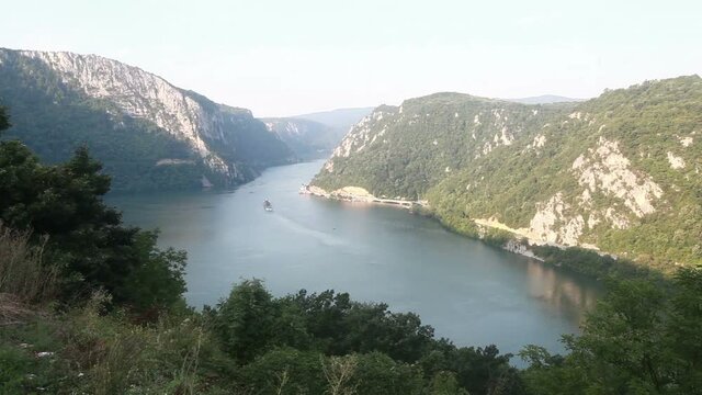  Danube river summer landscape. The cruiser ship passes through the part of the gorge on the Danube between Serbia and Romania, also known as the Iron Gate.