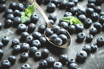Freshly harvested blueberries on the spoon. Selective focus. Shallow depth of field.
