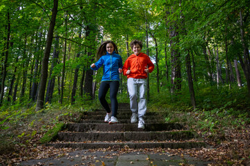 Girl and boy running in city park