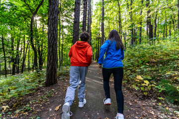 Girl and boy running in city park