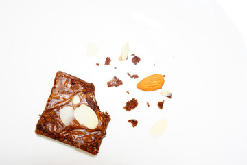 Almond Brownies bitten off on white background