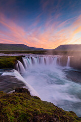 Big blue stream of Godafoss Waterfall and colourful of sky cover  lava rock cliff in twilight, Summer, Iceland.