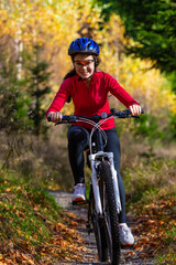 Fototapeta premium Healthy lifestyle - teenage girl biking in forest 