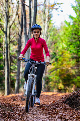 Fototapeta premium Healthy lifestyle - teenage girl biking in forest 
