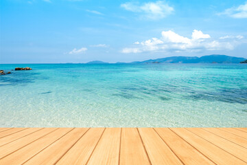 Fototapeta premium Empty wooden board table top with blurred beautiful blue or turquoise Ocean and beautiful blue sky.