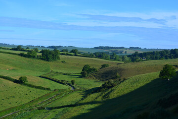 View over valley, green fields and rolling hills from Donkey Lane trail, a trypical English summer landscape, Dorset, UK