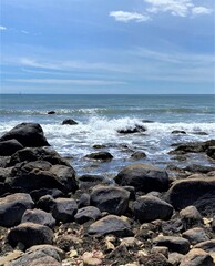 View of a rocky beach on a sunny day in Weekapaug, Rhode Island 