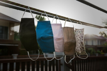 Reused fabric facemask drying after washing and preparing for workday use. They will be reused as the neccessary tool to prevent COVID-19 during the working day. This is a new normal.