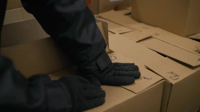 Large cardboard boxes in stock before shipping. Cardboard boxes with frozen fish. Fish production. Big fish packs fish in a cardboard box.