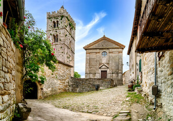 Fototapeta na wymiar Town of Hum, old narrow street and church view, region of Istria, Croatia. Hum is the smallest town in the world.