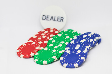 Casino chips, ace of hearts card and plaque with dealer inscription.