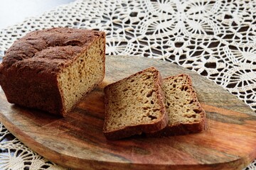 View of slices rye of bread on hand knitted tablecloth background