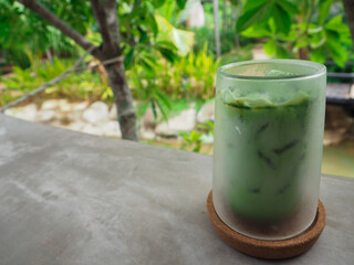 The cup is placed on the table and there is a beautiful nature around in Thailand.