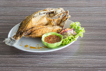 fried fish and seafood sauce on wood table background, Thai food. - 355907739