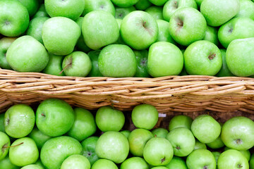 Green apples in the Market. Apples lie in boxes in front of the buyer. Healthy food
