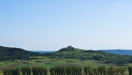Scenic view from the vineyards of the village Unterjesingen to the chapel St. Remigius (Wurmlinger Kapelle) at a day with clear blue sky.
