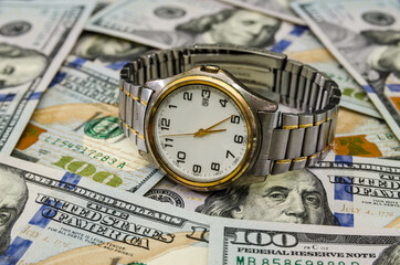 men's wristwatch on a background of dollars.