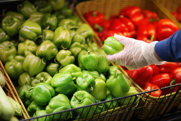 Supermarket shopping, face mask and gloves,man buying vegetables at the market,pepper	