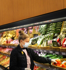 Supermarket shopping, face mask and gloves,Woman buying vegetables at the market	
