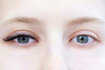 Eyelash extensions. Closeup of eyes with extended eyelashes and without extended eyelashes, white girl. before and after