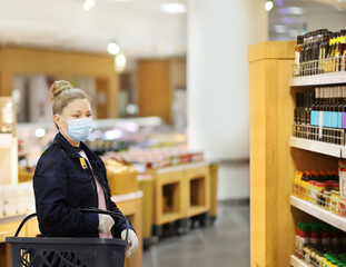 supermarket shopping, face mask and gloves,Woman choosing a dairy products at supermarket