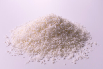 
A pile of coconut flakes on a white background.Close-up.