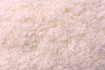 Shredded coconut flakes abstract texture background. Background from coconut flakes.