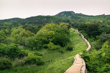 Stone wall of castle built on the top of a famous Geumjeongsan mountain in Busan, South Korea.