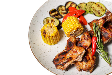 Grilled chicken wings with vegetables on a white background