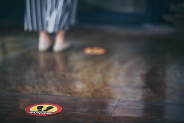 red round sign printed on ground at the font of cafe., People wearing face mask and standing keep distance in line due to coronavirus pandemic safety guideline, COVID-19 social distancing quarantine